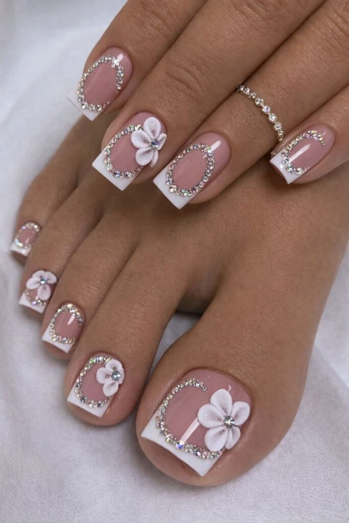 French nails :French pedicure with white tips and small hand-painted white flower accent on the big toenail]